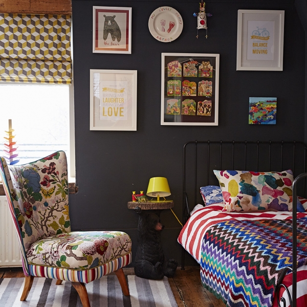 Kids bedroom designed by Sophie Robinson in her signature black with pops of bright colour which is ideal for a kids room as the brights look striking against the dark interior. photograph by Alun Callender