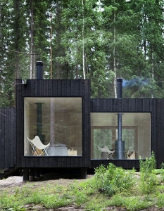 black weatherboard cabin on the woods
