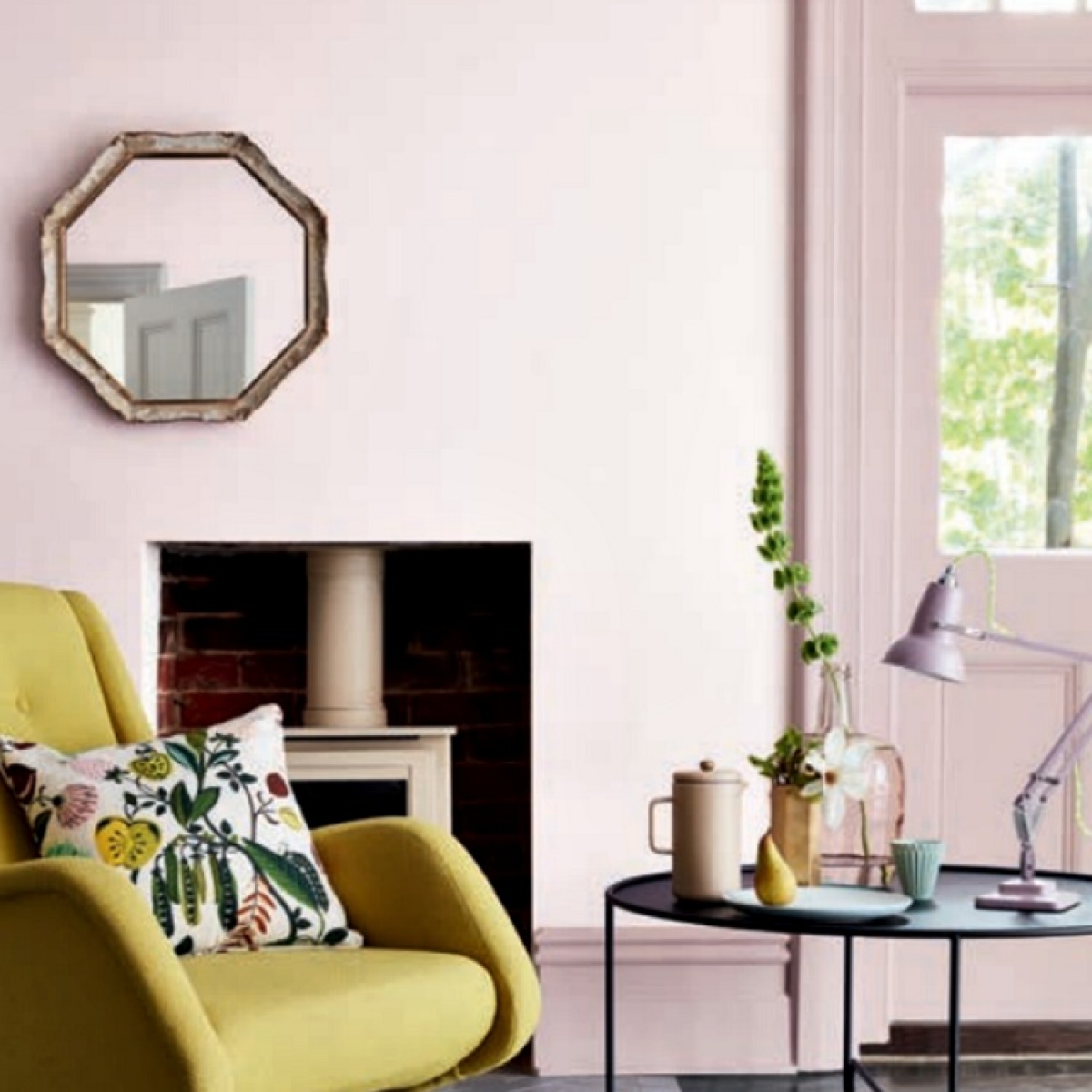 pale pink walls in livingroom is freshened up with lime yellow mid century modern chair. walls painted in Dorchester mid by Little Green paint