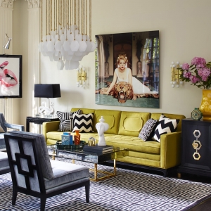 The striking yellow sofa and glossy artwork dipicts the glamour of the winter personailty. Sharp lined furniture and geometric zig zag chevron cushions all make up this glamourous living room designed by Jonathon Adler