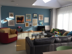A galeery wall is the ideal way to make a focal point in an interior design scheme. This blue living room with modular corner sofa is the perfect setting for a collection of art
