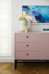 A pale pink sideboard from Naked Kitchens matches nicely with the abract artwork by Sophie Abbitt. Interior design by Sophie Robinson