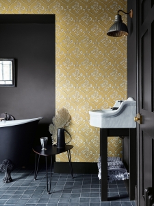 Interior designer Sophie Robinson talks about interiors mustard trend, Cranford wallpaper in Wheat by Little Greene shown in bathroom with black accents