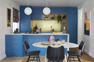 marine blue kitchen by naked kitchens designed by sophie robinson for the ideal home show. gold kitchen splash back, gold kitchen taps and ercol mid century modern table and chairs