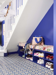 Sophie Robinson has transformed her hallway into a bright and welcoming entrance. Open shoe storage under the stairs creates a sense of space and patterned seat cushions creates a fun and striking focal point. #sophierobinson #hallway #shoestorage