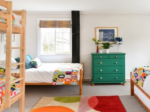 Volunteers bring donated furniture to life with a lick of bold paint. A fresh and welcoming kids bedroom in the renovated Jamies Farm farmhouse. #sophierobinosn #kidsbedroom #greencabinet