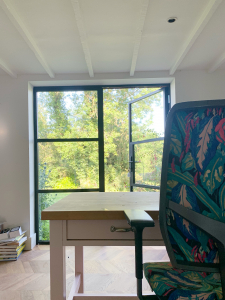 Interior Designer Sophie Robinson re-designed her home office to open up the view of the garden with some crittall style doors. The office chair also had a makeover with botanical print fabric by Linwood. #homeoffice #sophierobinson #linwood