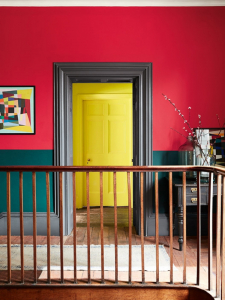 The ultimate in colour blocking, the two-tone walls and doorframe in contrasting colours are set of by the distant yellow painted door all creates a striking look. #thegreatindoors #sophierobinson #colourblocking