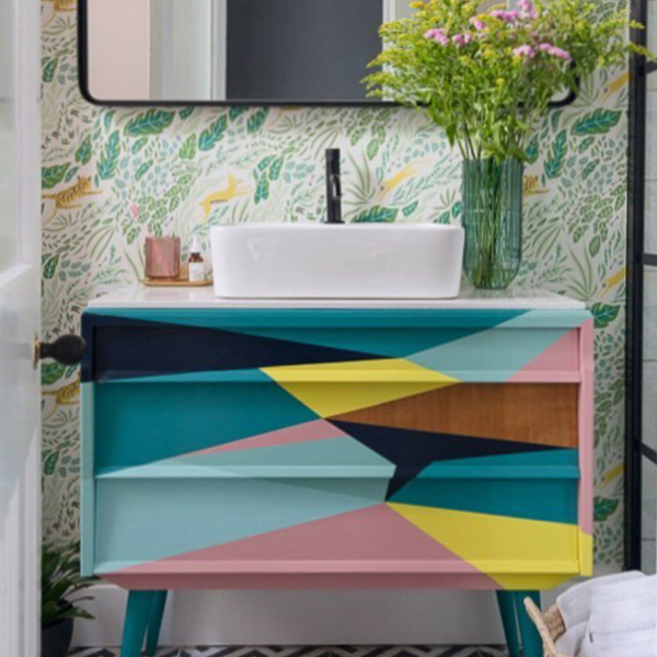The overall winner in the Anglian Styled By Me Competition. Judge Sophie Robinson loves patterned wallpaper in a small bathroom, as it adds a splash of character and interest. The painted basin unit is a unique design featuring an abstract painted effect taking inspiration from the colours in the wallpaper. #bathroomdesign #paintedunit #sophierobinson