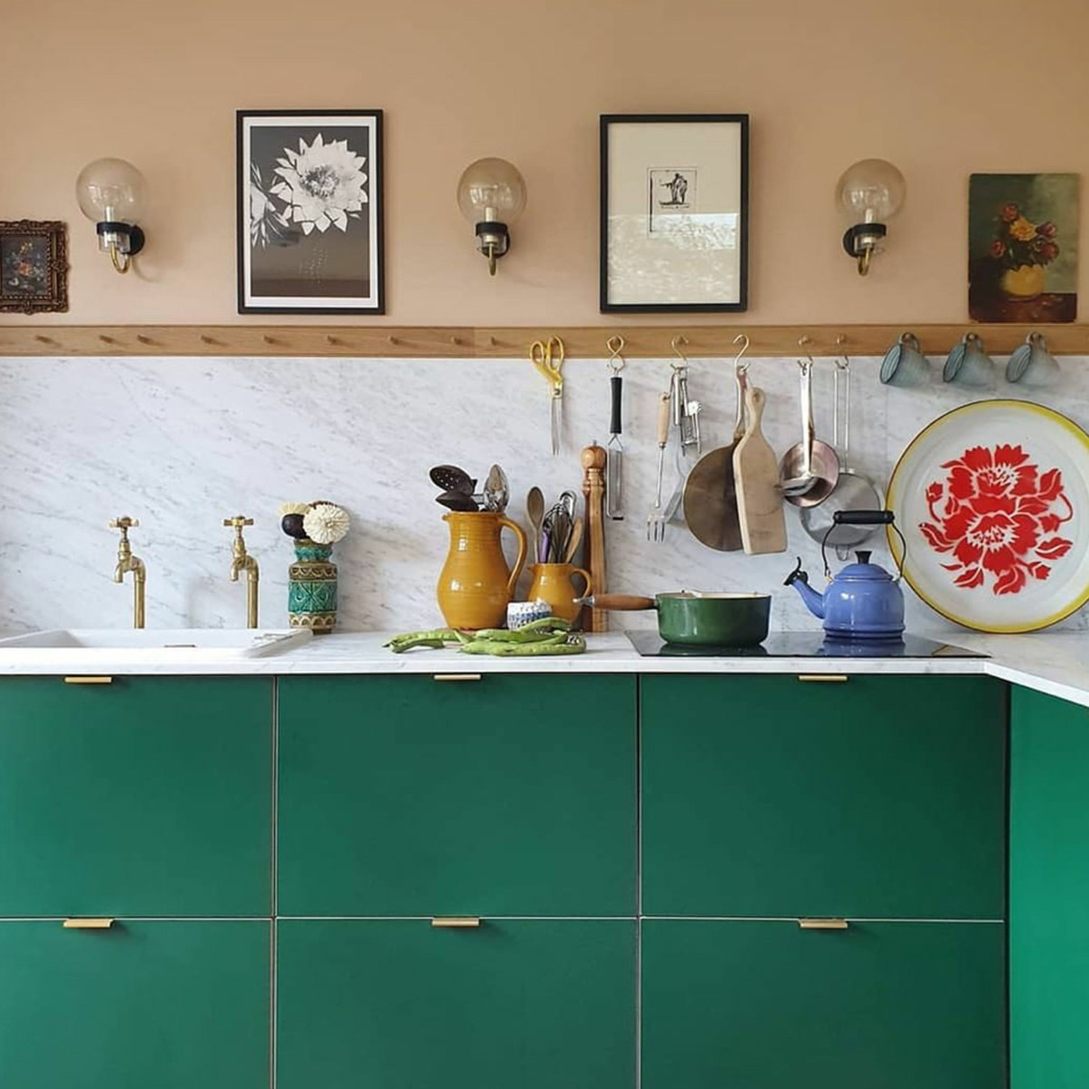An instant update to the Ikea kitchen - Plykea supply plywood doors and worktops for Ikea kitchens and these bold green doors sit perfectly with the peach walls. For a practical touch a handy peg rail is used for a variety of utensils. #plykeakitchens #colourfulkitchens #sophierobinson
