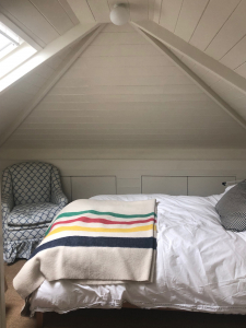 Interior designer Sophie Robinson and Kate Watson-Smyth take a tour around the home of Laura Jackson for the Great Indoors podcast. The first room to be renovated is the attic space, with tongue and groove walls and ceilings and hidden storage. #bedroom #thegreatindoors #podcast #sophierobinson #attic