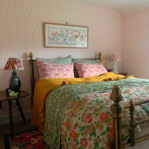 Interior designer Sophie Robinson and Kate Watson-Smyth discuss getting the bedroom ready for winter on the Great Indoors podcast. As shown here, Sophie's guest bedroom features a mix of patterns and colours. Soft pinks and greens are great colours for sleep and a subtle pattern for the walls keep the look cohesive. #sophierobinson #guestbedroom