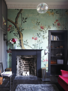 Chinoiserie wallpaper with black fireplace and black alcove shelving in a compact living room