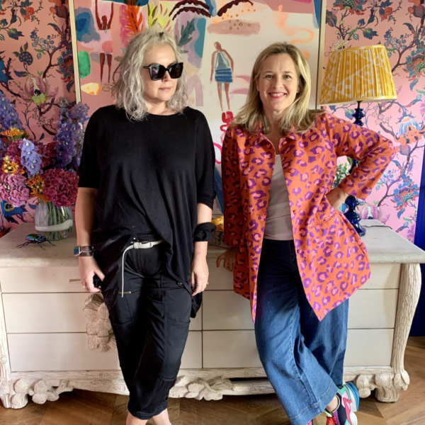 Kate Watson-Smyth and Sophie Robinson in Sophie's home office with bold pink floral wallpaper and large vintage sideboard.